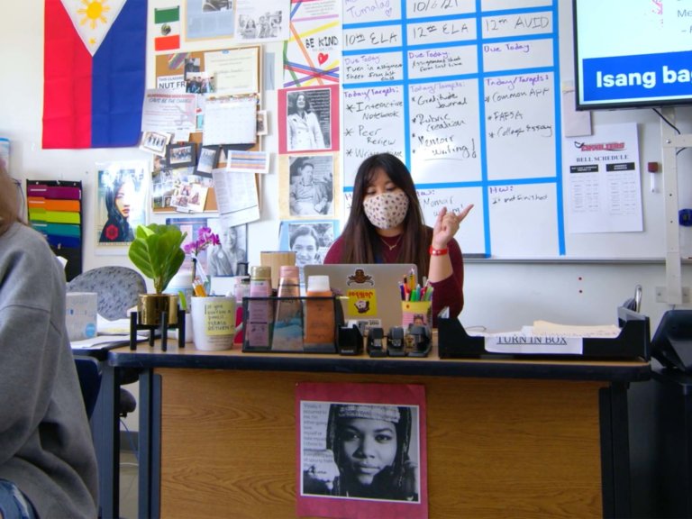 Ethelyn seated at her desk while teaching