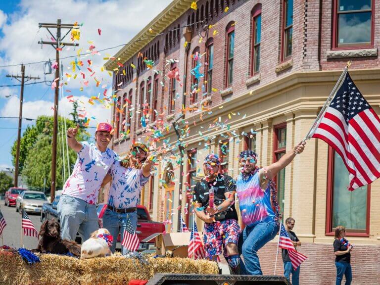 Several people celebrate on a float in a parade