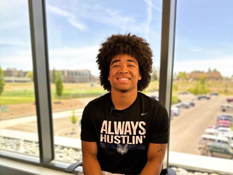 Jamison, a student athlete, is interviewed in a t-shirt that reads Always Hustlin'