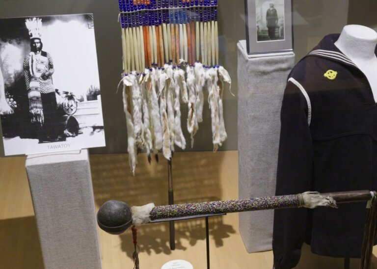 Indigenous regalia sits beside US armed forced uniform pieces at the interpretive center at the CTUIR.