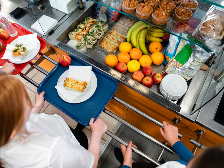 Students wait in line at the school lunch counter